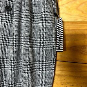 White and black plaid Pants with suspenders.